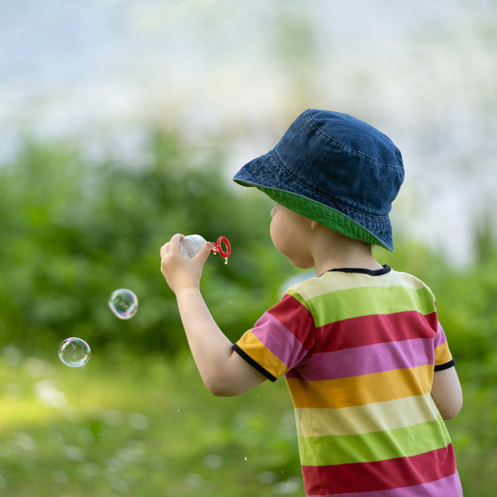 Little boy blows soap bubbles